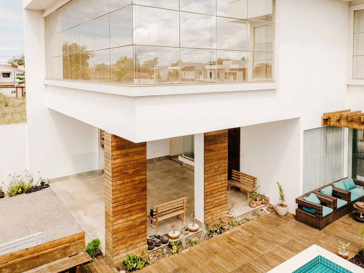 Modern luxury residential property with a glass facade and swimming pool at twilight, representing residential mortgage financing.